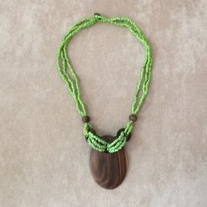 Green necklace with wood charm